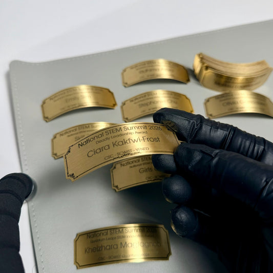 Custom engraved brass name plates for trophies & awards Canada - personalized gold metal base plates with name, title & date. Ships Canada & USA.